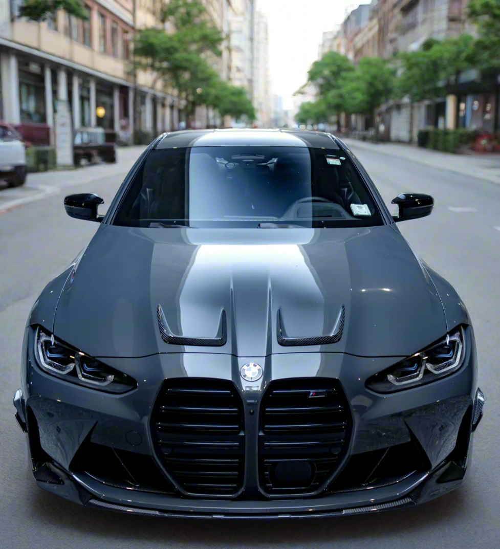Close-up of BMW G80 M3 carbon fiber hood trim texture